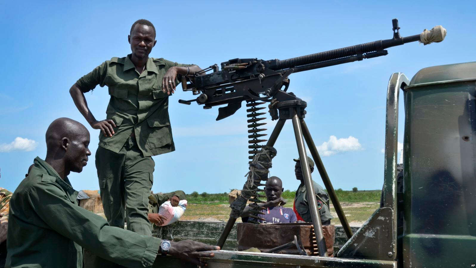 (1/1)FILE - Government soldiers stand guard by their vehicle on the front lines in the town of Kuek, northern Upper Nile state, South Sudan, Aug. 19, 2017. 